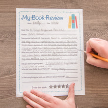 Load image into Gallery viewer, child writing on my book review printable page on wood background
