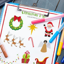 Load image into Gallery viewer, Christmas ispy page on blue clipboard with markers and wood background
