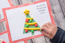 Load image into Gallery viewer, child hand playing with red green yellow playdoh on printable Christmas playdough mats
