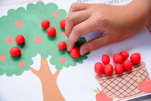 Load image into Gallery viewer, child putting play doh apples on apple tree playdough mat
