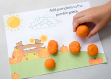 Load image into Gallery viewer, child putting orange pumpkin playdoh on fall playdough mat
