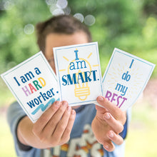 Load image into Gallery viewer, boy holding positive affirmation cards
