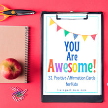 Load image into Gallery viewer, black clipboard with you are awesome positive affirmations for kids with notebook, apple, scissors on red background
