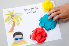 Load image into Gallery viewer, child decorating playdough shells on summer beach scene playdough mat
